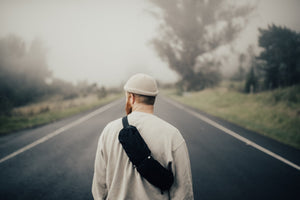2L Sling Belt (42L Backpack Waist Belt/Sling Bag) - Gravel - Man wearing 2 Liter sling bag across back walking down the street